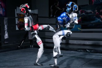The Humbling of the Gloating Robot: A Historic Humanoid Boxing Match